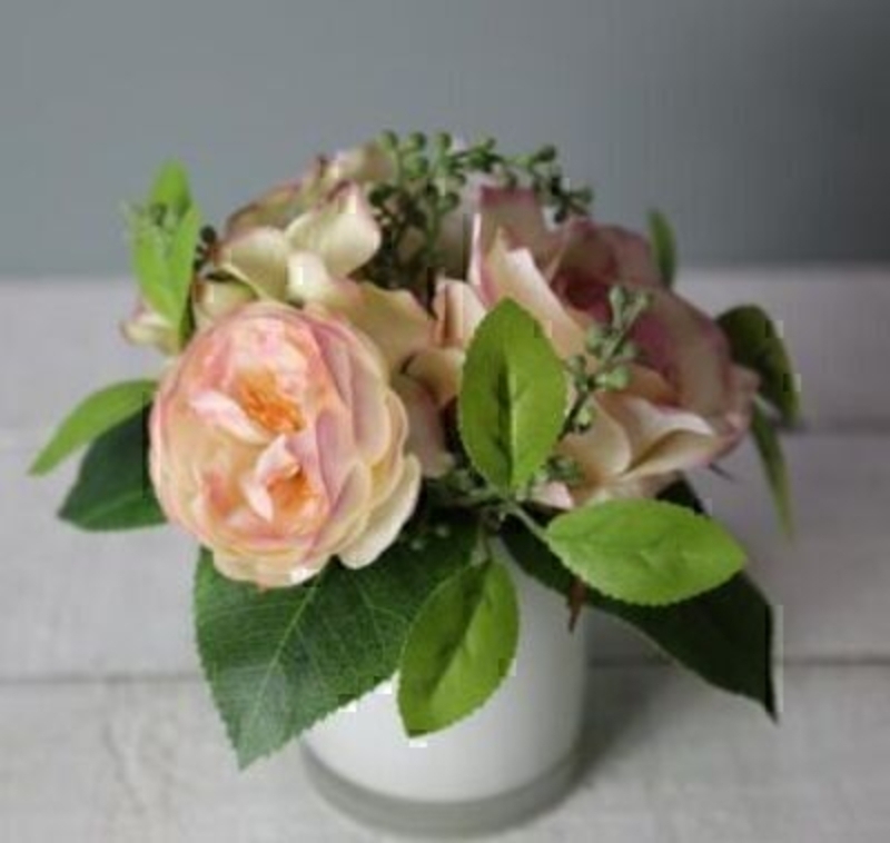 Peach Cream Artificial Rose Flower Arrangement in pot by Bloomsbury. White Glass Pot. Can also be called silk flowers the quality of these artificial flowers by Bloomsbury is second to none. For Realistic fake or silk flowers Bloomsbury are the perfect
